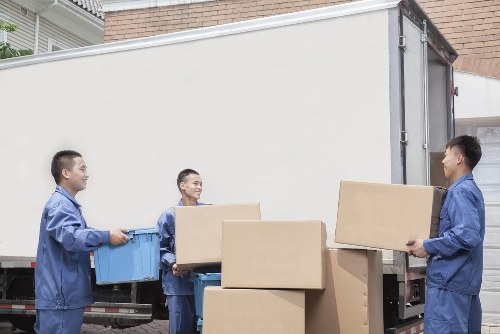 Students organizing belongings into storage boxes in Wimbledon